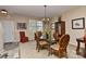 Dining area featuring a glass table with seating for six under a decorative chandelier at 5011 Blue Stream Ln, Indian Trail, NC 28079