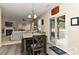 Charming dining area with modern table, sliding glass door to outdoor deck, and view of living room at 5011 Blue Stream Ln, Indian Trail, NC 28079