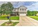 Charming two-story home with well-maintained landscaping, a two-car garage, and inviting curb appeal at 5011 Blue Stream Ln, Indian Trail, NC 28079
