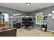 Comfortable home office with gray walls, a dual-screen workstation, and a window view at 5011 Blue Stream Ln, Indian Trail, NC 28079