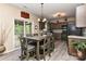 Kitchen and dining area with dark cabinets, stainless steel appliances, and sliding door to outdoor deck at 5011 Blue Stream Ln, Indian Trail, NC 28079