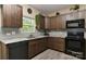 Well-equipped kitchen with stainless steel appliances, granite countertops and dark wood cabinetry at 5011 Blue Stream Ln, Indian Trail, NC 28079