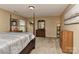 Spacious bedroom featuring a bed, carpeted floors, and large windows at 5011 Blue Stream Ln, Indian Trail, NC 28079