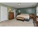 Spacious main bedroom featuring neutral carpet, pale green walls, and a ceiling light fixture at 5011 Blue Stream Ln, Indian Trail, NC 28079