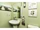 Stylish powder room with a decorative mirror, wall sconce, and tasteful decor at 5011 Blue Stream Ln, Indian Trail, NC 28079