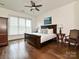 Spacious bedroom with hardwood floors, ceiling fan, and a large window with plenty of natural light at 5425 Closeburn Rd, Charlotte, NC 28210