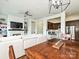 Open-concept living space with a built-in entertainment center, fireplace, and eat-in kitchen at 5425 Closeburn Rd, Charlotte, NC 28210