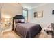 Cozy bedroom featuring elegant decor, soft carpet, and natural light from the window at 5957 Redwood Pine Rd, Concord, NC 28027