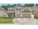 Two-story home with a two-car garage, neutral siding, stone accents, and a well-manicured front yard at 5957 Redwood Pine Rd, Concord, NC 28027