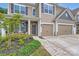 Charming front entrance with stone accents, a cozy porch, and well-maintained landscaping at 5957 Redwood Pine Rd, Concord, NC 28027