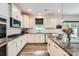 Well-lit kitchen featuring granite countertops, white cabinets, and stainless steel appliances at 5957 Redwood Pine Rd, Concord, NC 28027