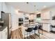 Modern kitchen with white cabinets, granite countertops, stainless steel appliances, and a center island at 5957 Redwood Pine Rd, Concord, NC 28027