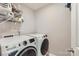 Modern laundry room with front loading washer and dryer and wire shelving for storage at 5957 Redwood Pine Rd, Concord, NC 28027