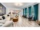 Bright living room with modern decor, wood floors, and large windows, adjacent to an open kitchen at 5957 Redwood Pine Rd, Concord, NC 28027