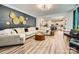 Stylish living room with a dark accent wall, modern lighting, and an open floor plan to the kitchen at 5957 Redwood Pine Rd, Concord, NC 28027