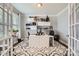 Bright home office with modern white desk, floating shelves, and stylish patterned rug at 5957 Redwood Pine Rd, Concord, NC 28027