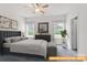 Relaxing bedroom with neutral tones, dresser, and ample natural light from the windows at 6005 Jasmine Branch Rd, Charlotte, NC 28216