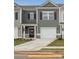 Charming townhome featuring a one car garage, covered entry, and neutral color palette at 6005 Jasmine Branch Rd, Charlotte, NC 28216