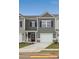 Charming gray townhome featuring a one-car garage and a covered front porch at 6005 Jasmine Branch Rd, Charlotte, NC 28216