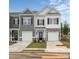 Charming two-story townhome featuring stone accents, a single-car garage, and a welcoming front entrance at 6005 Jasmine Branch Rd, Charlotte, NC 28216