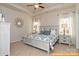 Serene main bedroom with a tray ceiling, neutral carpet, and large windows at 6005 Jasmine Branch Rd, Charlotte, NC 28216
