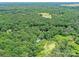 Aerial view of a home surrounded by a pond and dense trees providing both privacy and natural beauty at 615 Hawley Rd, McConnells, SC 29726