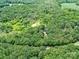 Expansive aerial view of the property, surrounded by a dense canopy of trees and lush greenery at 615 Hawley Rd, McConnells, SC 29726