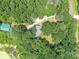An aerial view displays a home with a gray roof, surrounded by lush trees, offering a private and secluded setting at 615 Hawley Rd, McConnells, SC 29726