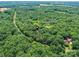 Overhead view pinpoints property amidst extensive woods and a stream nearby, offering privacy and natural beauty at 615 Hawley Rd, McConnells, SC 29726