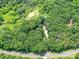 Scenic aerial view of a property surrounded by lush greenery, a pond and a road nearby at 615 Hawley Rd, McConnells, SC 29726