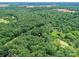 A captivating aerial view of a property nestled in dense woods near a pond, marked by a home symbol at 615 Hawley Rd, McConnells, SC 29726