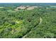 Lush greenery and a winding road surround a home, complemented by distant fields, providing both privacy and accessibility at 615 Hawley Rd, McConnells, SC 29726