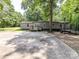 Backyard with a small deck and patio with grey siding on the home at 615 Hawley Rd, McConnells, SC 29726