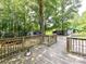 Wooden deck overlooking a large, wooded backyard with storage sheds at 615 Hawley Rd, McConnells, SC 29726