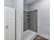 Bathroom featuring a walk-in shower with stylish gray tiles and built-in shelving at 615 Hawley Rd, McConnells, SC 29726