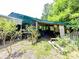 Rustic outbuilding with a partial green metal roof and plants growing through the open structure at 615 Hawley Rd, McConnells, SC 29726