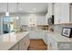 Modern kitchen with sleek white cabinetry, quartz countertops, and a stylish tile backsplash at 6423 Mallow Crossing Ln, Charlotte, NC 28213