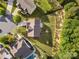 Overhead view of a home boasting a well-manicured lawn, patio, and bordering mature trees at 6430 Stirling Ln, Indian Land, SC 29707