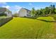 Extensive backyard with a lush lawn and tree line, offering plenty of space for recreation at 6430 Stirling Ln, Indian Land, SC 29707