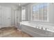 Bright bathroom with a large soaking tub, a separate shower and an abundance of natural light at 6430 Stirling Ln, Indian Land, SC 29707