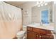 Cozy bathroom featuring a white vanity, toilet, and neutral colored shower curtain at 6430 Stirling Ln, Indian Land, SC 29707