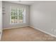Bedroom with neutral walls, carpet, and a large window at 6430 Stirling Ln, Indian Land, SC 29707