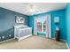 Bright bedroom with blue walls, white trim, and a crib at 6430 Stirling Ln, Indian Land, SC 29707