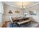 Formal dining room with a chandelier, decorative ceiling, and wainscoting details at 6430 Stirling Ln, Indian Land, SC 29707