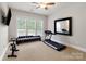 Bright exercise room with natural light, a treadmill, and weights at 6430 Stirling Ln, Indian Land, SC 29707