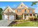 Charming two-story brick home with a manicured front yard and a two-car garage at 6430 Stirling Ln, Indian Land, SC 29707