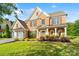 Beautiful two-story home with brick and siding exterior, lush lawn, and well-maintained landscaping at 6430 Stirling Ln, Indian Land, SC 29707