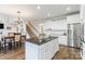 Bright kitchen with an island, stainless steel appliances, white cabinets, and hardwood floors at 6430 Stirling Ln, Indian Land, SC 29707