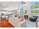Open-concept living room with large windows, a fireplace, and hardwood floors at 6430 Stirling Ln, Indian Land, SC 29707