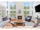 Spacious living room with a fireplace, large windows, and comfortable seating at 6430 Stirling Ln, Indian Land, SC 29707